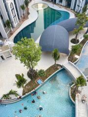 Aerial view of modern residential complex with pool and landscaped areas