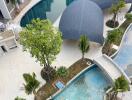 Aerial view of modern residential complex with pool and landscaped areas