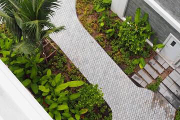 Aerial view of a landscaped walkway with greenery