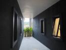 A well-lit hallway with modern design and outdoor greenery