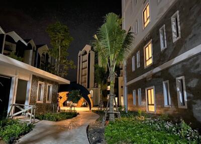 Night view of a residential complex with landscaped pathways