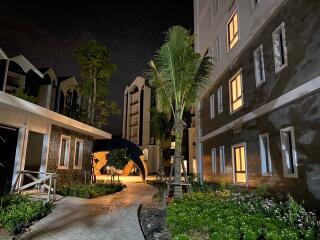 Night view of a residential complex with landscaped pathways