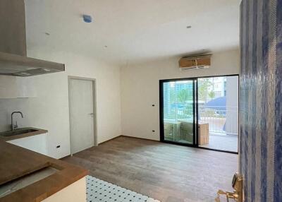 Living space with a wooden floor and kitchen area