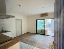 Living space with a wooden floor and kitchen area