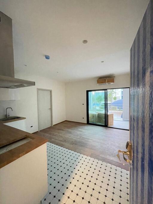 Living space with a wooden floor and kitchen area