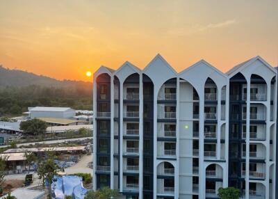 Modern apartment building with a scenic view at sunset