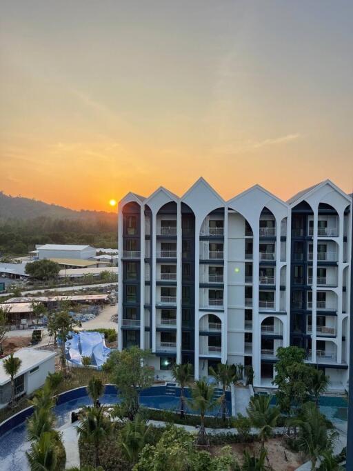 Modern apartment building with a scenic view at sunset