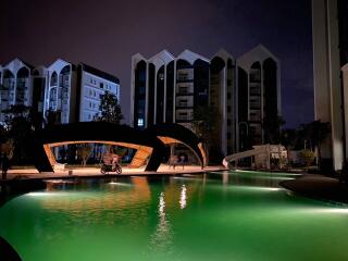 night view of swimming pool and modern residential buildings