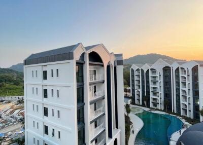 Exterior view of modern apartment buildings with a large swimming pool