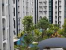 Modern apartment buildings with swimming pools and lush greenery