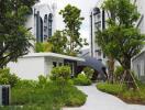 Modern residential buildings with lush greenery and pathway