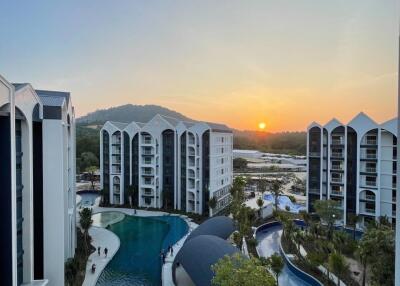 View of residential complex with swimming pools at sunset