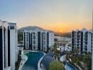 View of residential complex with swimming pools at sunset