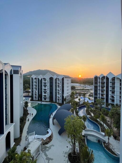 View of residential complex with swimming pools at sunset