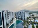 Modern apartment complex with swimming pools and scenic surroundings