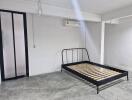 Minimalist bedroom with metal bed frame