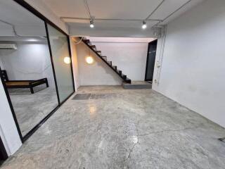 Main living space with staircase and large window