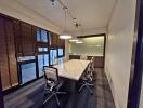 Well-lit conference room with a large marble table, modern chairs, and window blinds