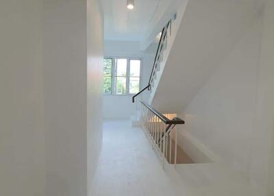 Bright staircase with window and handrail