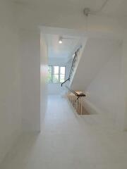 Bright staircase with window and handrail