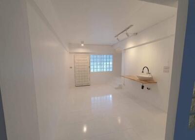 Minimalist white kitchen with sink and counter