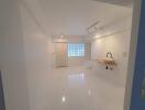 Minimalist white kitchen with sink and counter