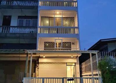 Four-story building with lit balconies