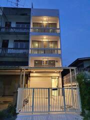 Four-story building with lit balconies