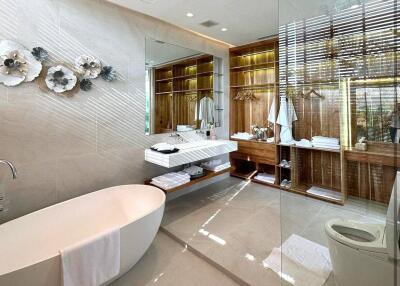 Modern bathroom with a bathtub, sink, and glass-enclosed shower