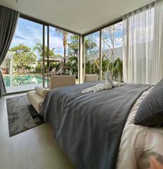 Modern bedroom with large windows overlooking a pool