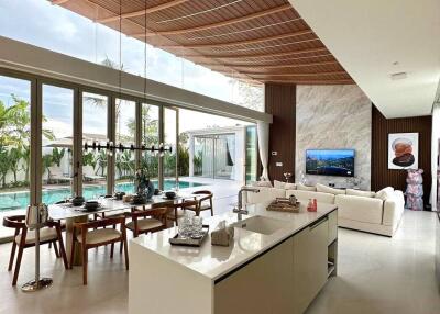 Spacious living area with open kitchen and pool view