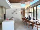 Modern dining area with high ceiling and natural light