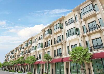 Exterior view of a multi-story residential building with storefronts