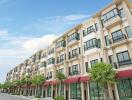 Exterior view of a multi-story residential building with storefronts