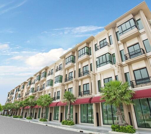 Exterior view of a multi-story residential building with storefronts