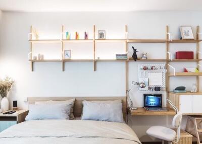 Cozy bedroom with a study nook and decorative shelving