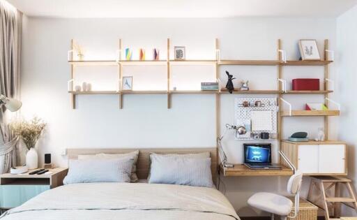 Cozy bedroom with a study nook and decorative shelving