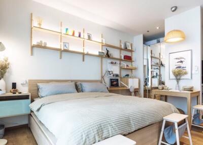 Modern bedroom with minimalist decor, wooden furniture, and shelving