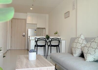 Modern living room with kitchen in the background