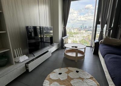 Modern living room with a large window providing a city view