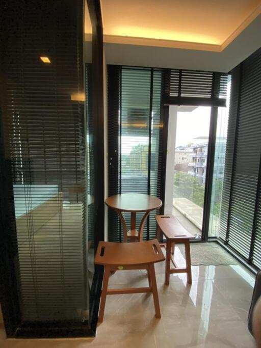 Modern balcony with table and chairs, overlooking cityscape