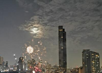 A night view of buildings with fireworks in the city.