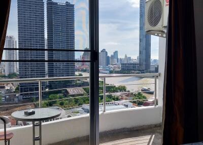 Bedroom with balcony view overlooking cityscape