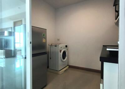 Laundry room with washing machine and refrigerator