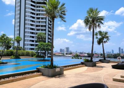 Outdoor area with swimming pool and city skyline view