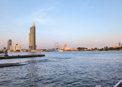 View of a waterfront with skyline and ferris wheel