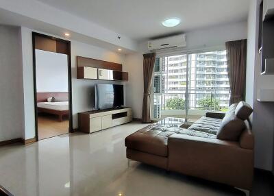 Modern living room with large windows and connected bedroom