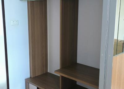 Built-in wooden wardrobe with empty hangers