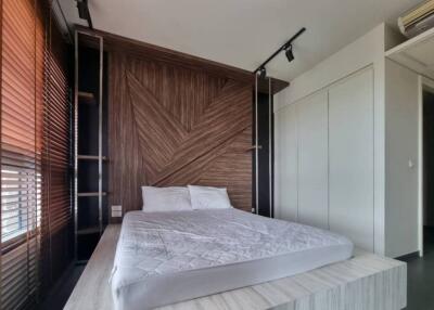 bedroom with wooden accent wall and platform bed