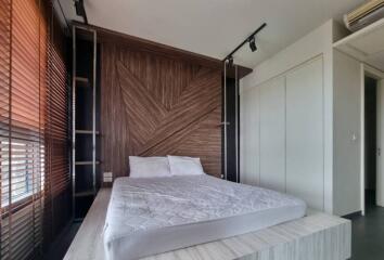 bedroom with wooden accent wall and platform bed